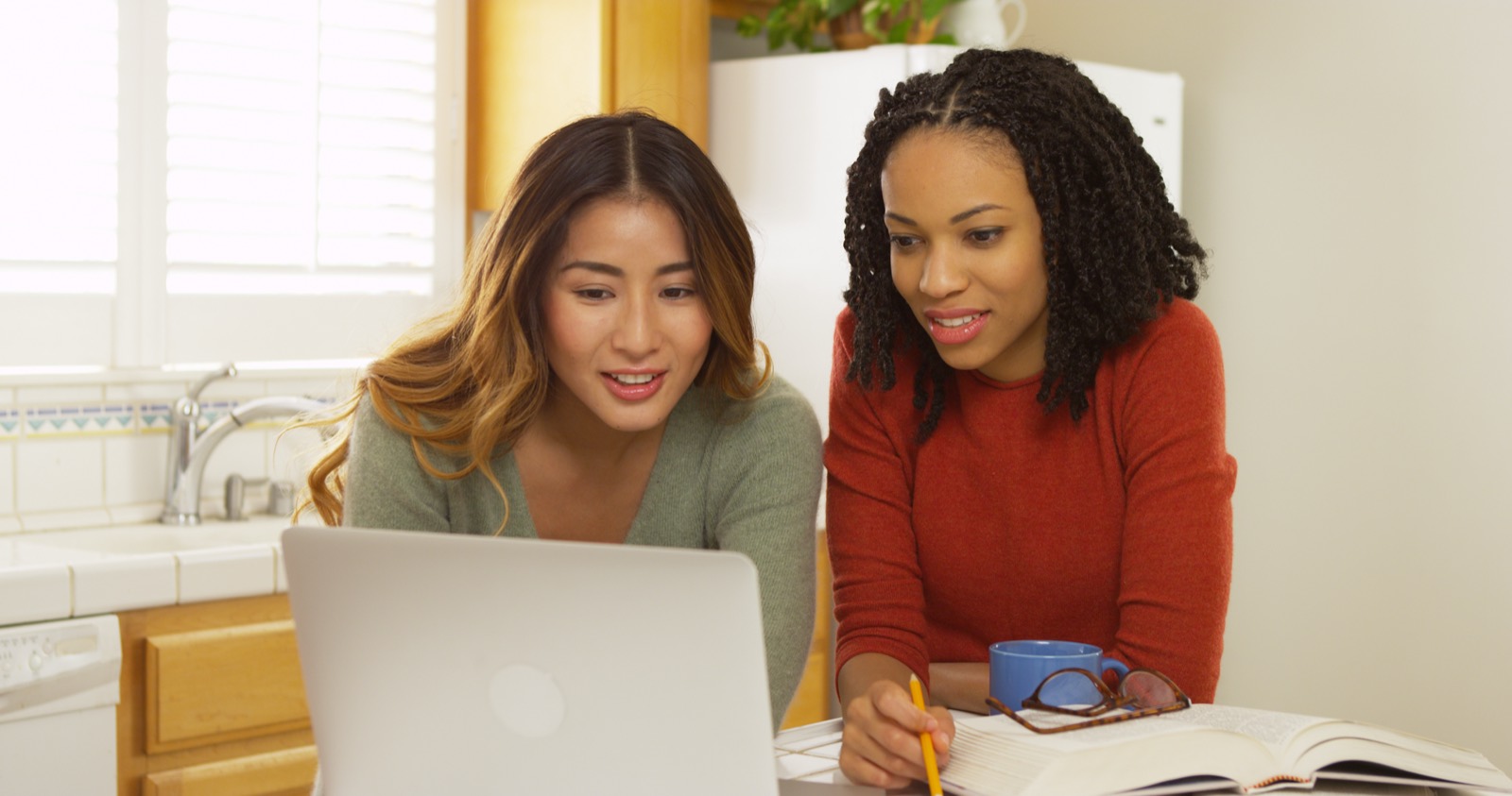 Two colleagues reviewing calls on a laptop