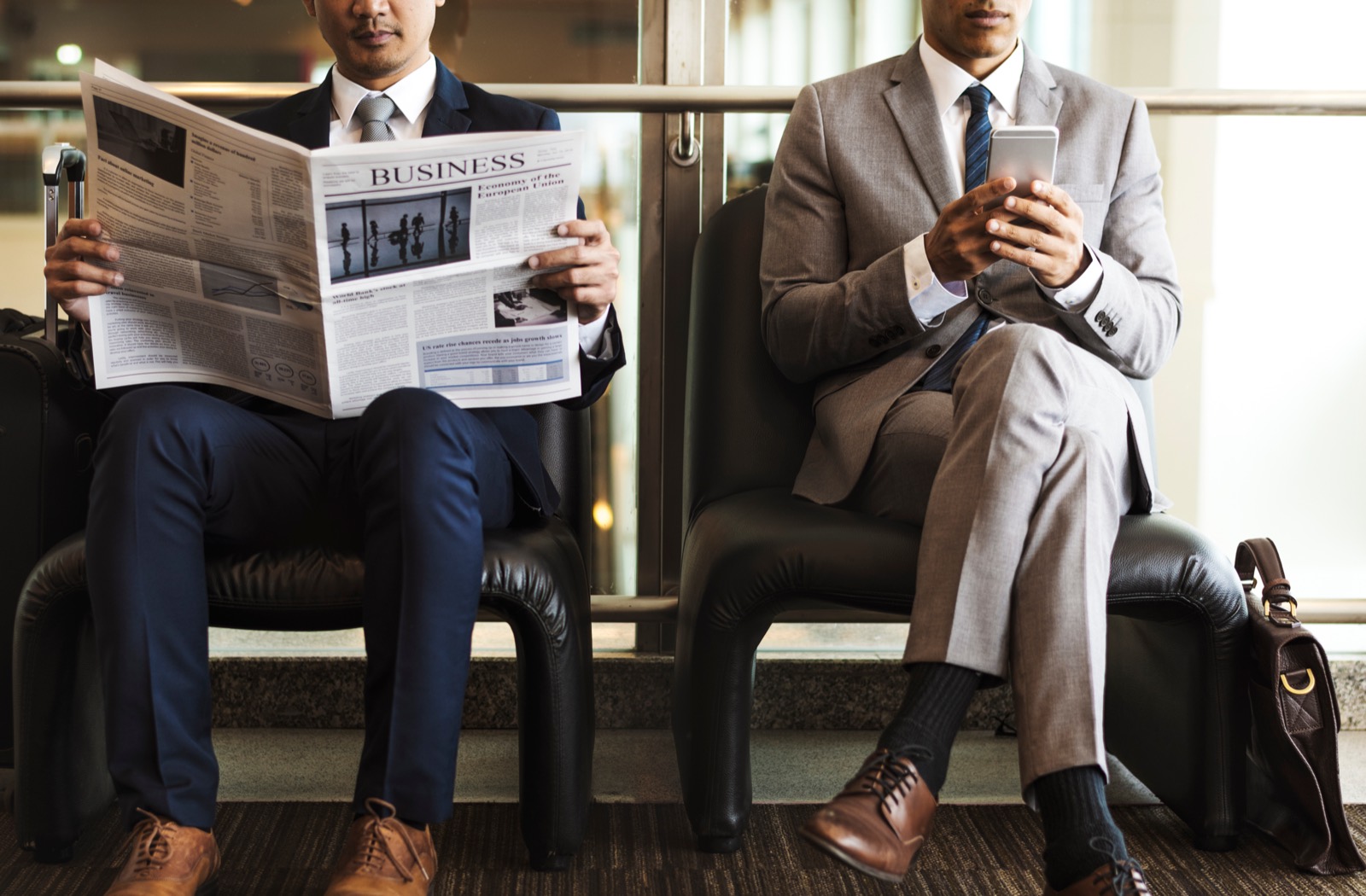 Business people waiting with phones and news