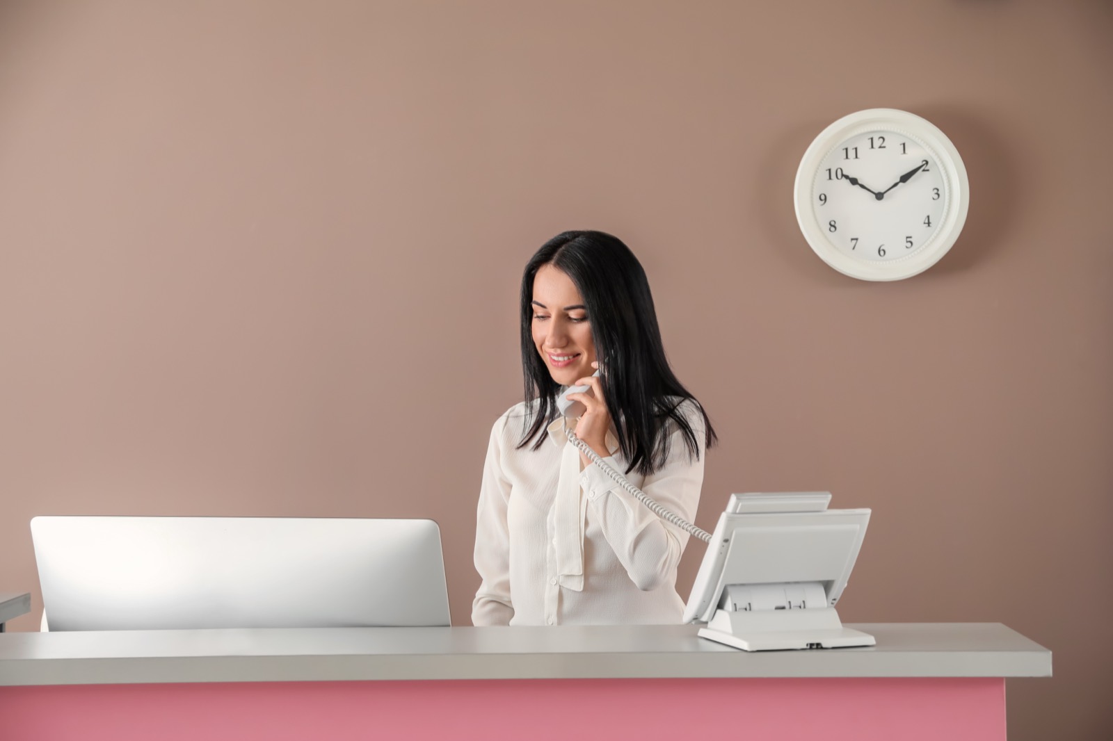 Dental front desk receptionist on the phone