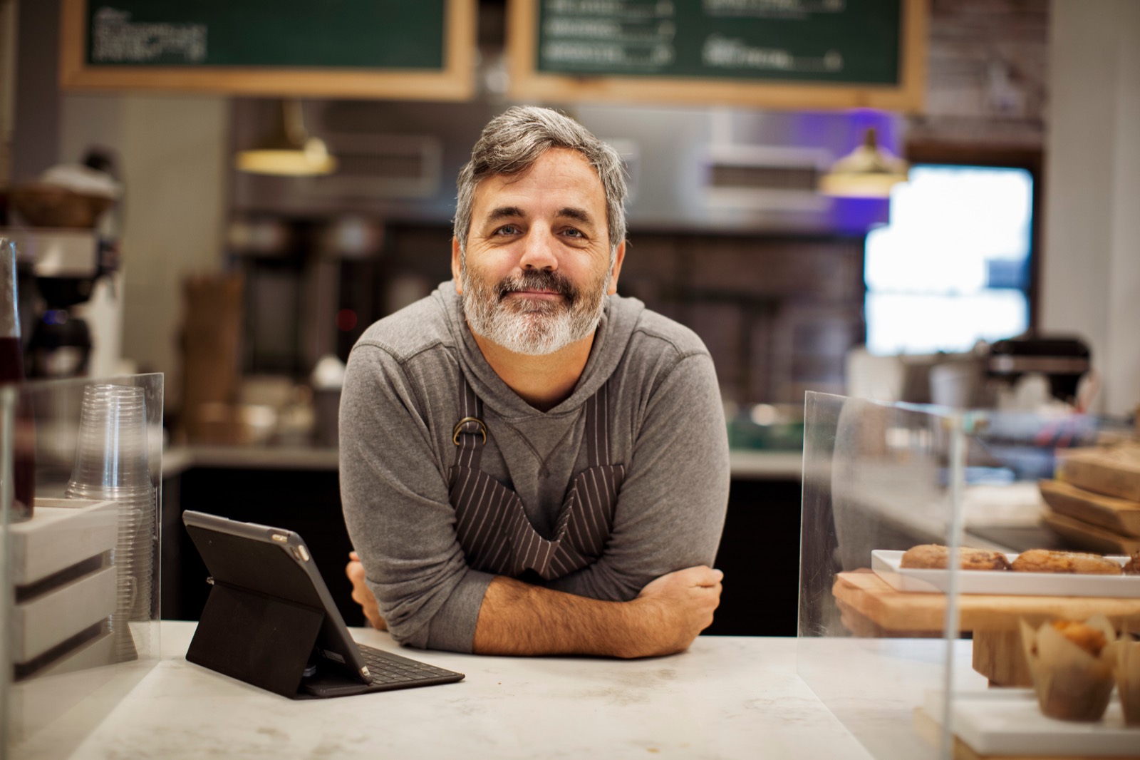 Business owner at his counter with a tablet