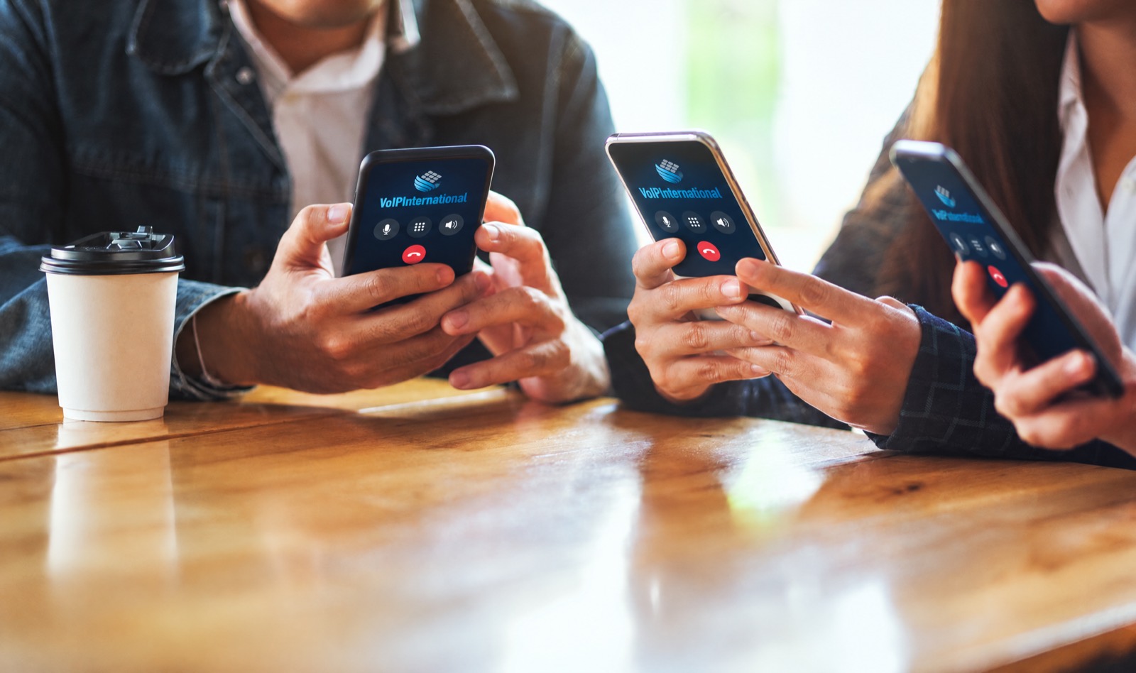 Colleagues using company phones at a table