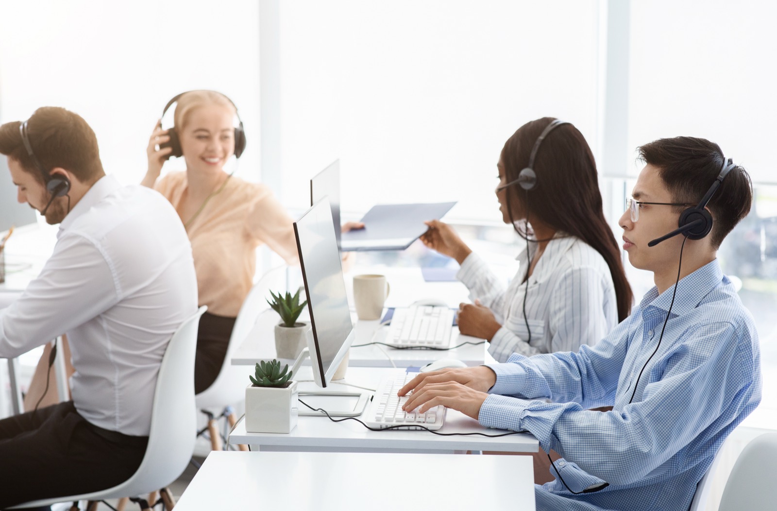 Sales team on headsets at their desks