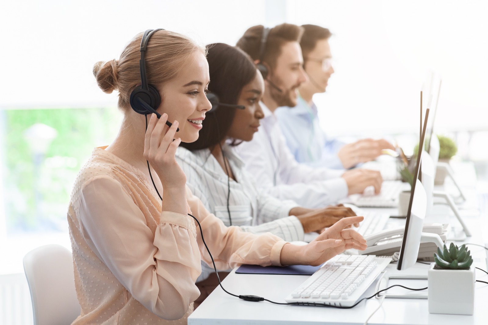 Agents on headsets helping callers
