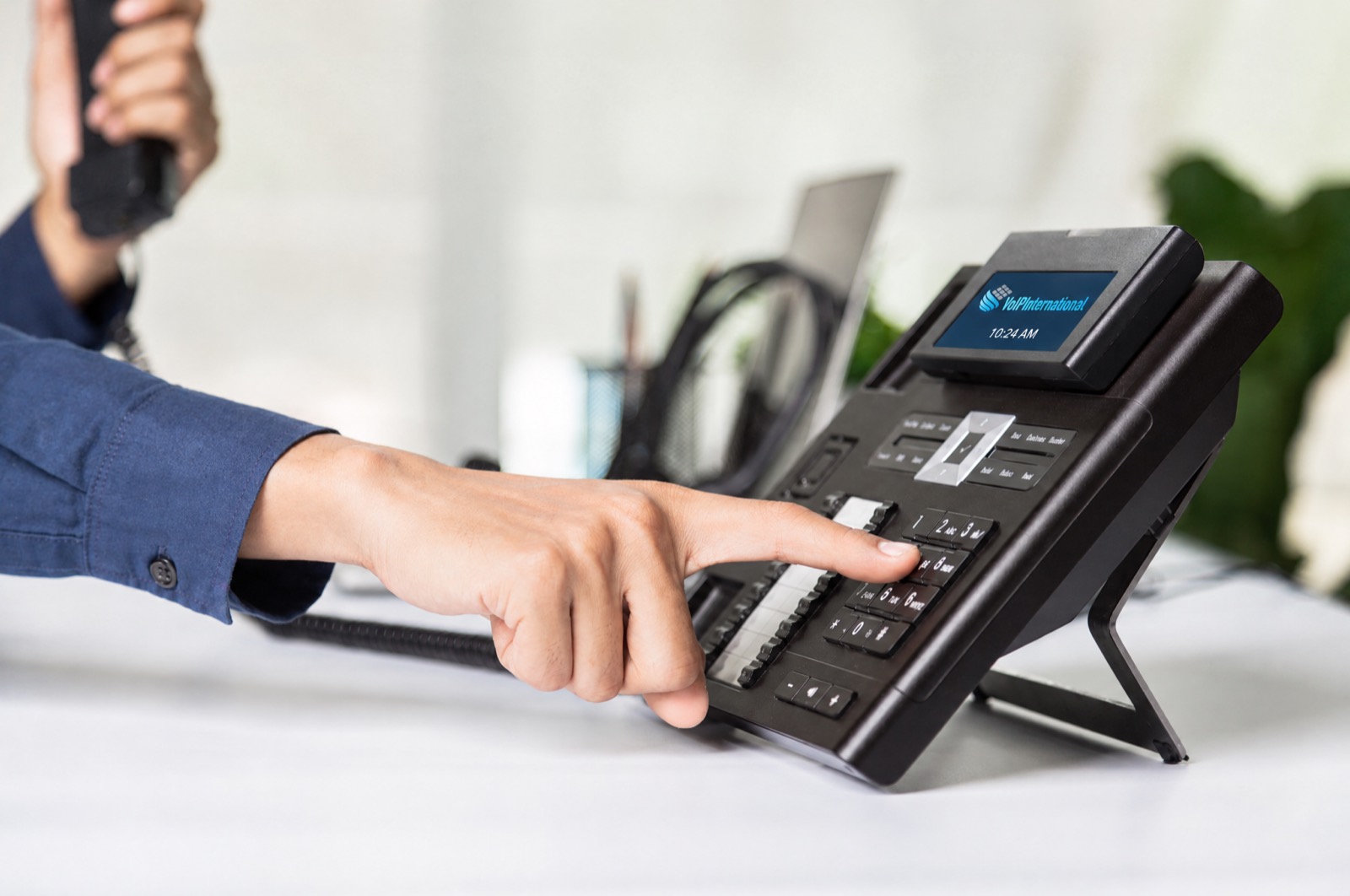 Hand dialing a business desk phone